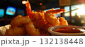 Delight in crispy fried shrimp accompanied by homemade cocktail sauce, perfect for sharing. 132138448