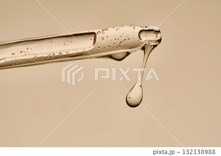 Serum in a pipette close-up on a beige background. 132138988