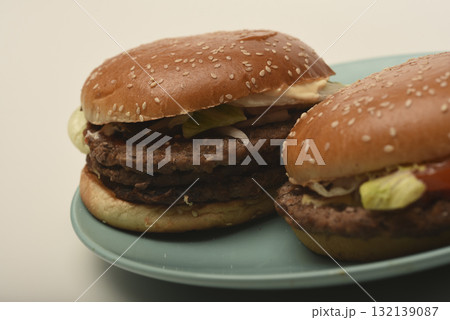 Hamburger with meat and vegetables. Fast food. Hamburger on a plate. Hamburger with meat and vegetables. Fast food. Hamburger on a plate. 132139087