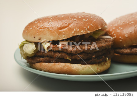 Hamburger with meat and vegetables. Fast food. Hamburger on a plate. Hamburger with meat and vegetables. Fast food. Hamburger on a plate. 132139088