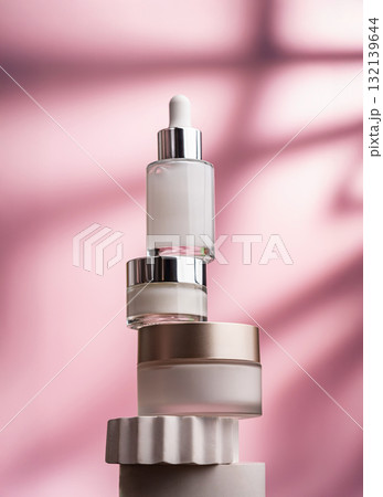 Anti-aging skincare set with serum and creams on pink background 132139644