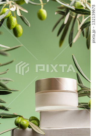 Anti-aging facial cream with olive branches and green background in natural composition Anti-aging facial cream with olive branches and green background in natural composition 132139678