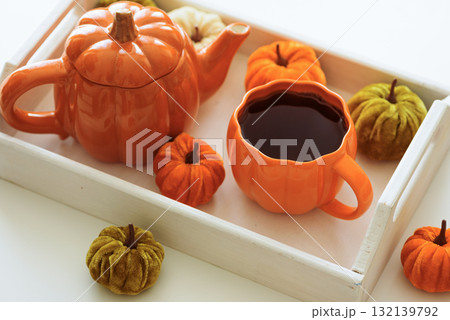 Autumnal tea set with pumpkin decor on a white tray. Autumnal tea set with pumpkin decor on a white tray. 132139792