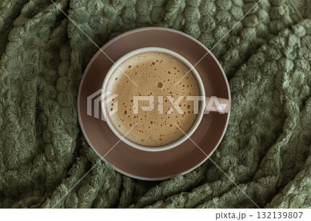 Cozy Living Room with Coffee Cup on Green Blanket Cozy Living Room with Coffee Cup on Green Blanket 132139807