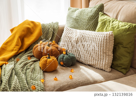 Cozy Autumn Living Room with Corduroy Pumpkins and Textured Blankets Cozy Autumn Living Room with Corduroy Pumpkins and Textured Blankets 132139816