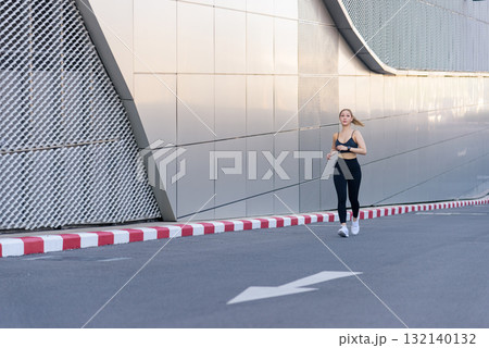 Woman, sport, exercise, workout, fit people enjoy outdoor running activity, dynamic stretch prepares athletic body, modern urban architecture enhances street training, good stretch aids muscle. Woman, sport, exercise, workout, fit people enjoy outdoor running activity, dynamic stretch prepares athletic body, modern urban architecture enhances street training, good stretch aids muscle. 132140132
