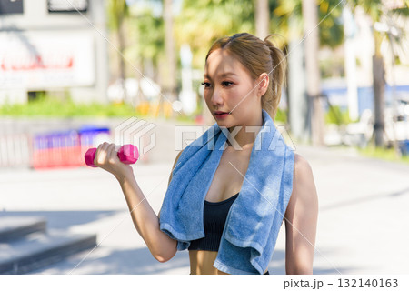 Fit woman, healthy outdoor sport workout exercise for people, lifting pink dumbbell, cultivating powerful fit physique, demonstrating committed routine. 132140163