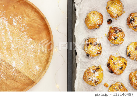 Eco friendly food banner with hande made natural sweet pastry on a baking sheet with wooden plate on a white background with copy space. Home made cookies with candied fruits and raisins. Flat lay 132140487