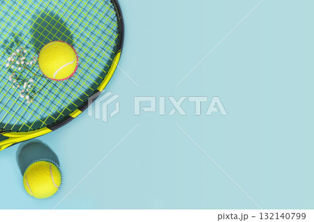 Tennis composition with yellow tennis balls and racket on a blue background of hard tennis court with copy space. Sport flat lay. The concept of outdoor game sports Tennis composition with yellow tennis balls and racket on a blue background of hard tennis court with copy space. Sport flat lay. The concept of outdoor game sports 132140799