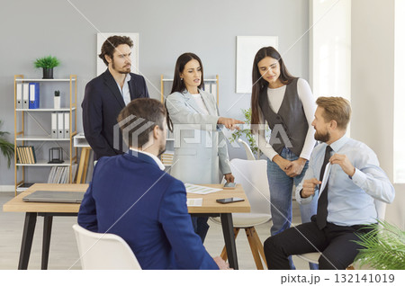 Business team reviewing sales performance, discussing strategies for financial growth during meeting 132141019