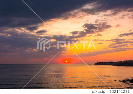 dramatic sky at sunrise at the sea. wonderful atmospheric background for wallpaper. stormy clouds above the water. sun over horizon. nature landscape of sozopol bay in summer. warm colorful gradient 132141281