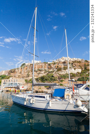 Mgarr marina vertical view taken on a sunny summer day, sailing yacht is moored 132141334
