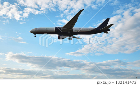 Airplane flying preparing for landing against a blue sky with clouds, travel and aviation 132141472