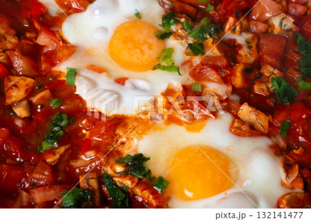 Shakshuka with eggs, tomatoes, and chicken pieces Shakshuka with eggs, tomatoes, and chicken pieces 132141477