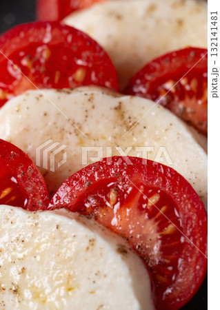 Classic Italian caprese salad with mozzarella, tomato, and olive oil 132141481