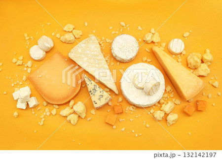 Colorful mix of cheese varieties: brie and camembert, blue gorgonzola and parmesan, gauda and cheddar. Food ingredients background 132142197