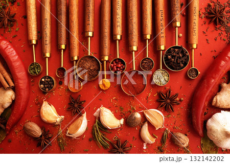 Colorful mix of herb and spice varieties: curry and coriander, turmeric and clove, paprika and pepper, cinnamon and garlic, cardamon and oregano	 132142202