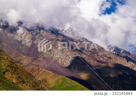 Majestic mountain landscape with rocks and clouds during daytime in Kyrgyzstan 132143865