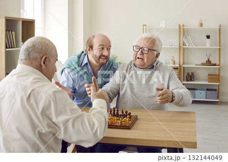 Group of angry senior people having argument during game of chess in retirement home 132144049