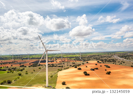 Wind turbines spanning across vast rural landscape 132145059