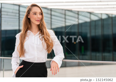 Smiling young businesswoman looking away with 132145062