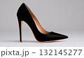 Elegant black high-heeled shoe displayed on a simple background 132145277