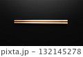 Wooden chopsticks placed on a black background for food preparation 132145278