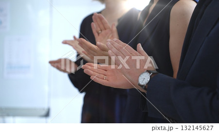 Group of business people clapping hands celebrating achievement, showing appreciation and support during a corporate meeting or seminar at a bright office conference Group of business people clapping hands celebrating achievement, showing appreciation and support during a corporate meeting or seminar at a bright office conference 132145627