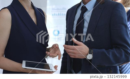 Business people applauding during a corporate conference, showing appreciation, celebrating success, and acknowledging achievement in a meeting event 132145999