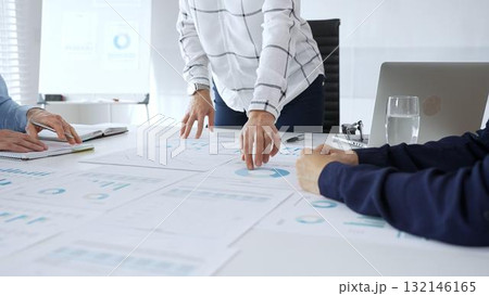 Business team analyzing financial charts during strategy meeting, professionals discussing data and performance metrics at workplace for decision making success 132146165