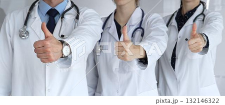 Medical professionals team showing thumbs up, indicating success, approval, positive feedback, and excellent healthcare service in a hospital or clinic setting Medical professionals team showing thumbs up, indicating success, approval, positive feedback, and excellent healthcare service in a hospital or clinic setting 132146322