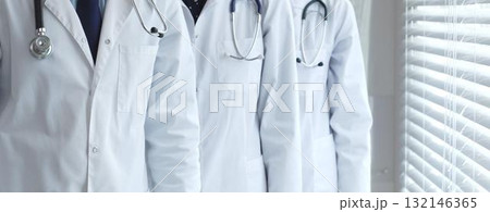 Medical team standing together, doctors and healthcare professionals wearing white lab coats and stethoscopes, symbolizing partnership and expertise in modern clinic or hospital environment Medical team standing together, doctors and healthcare professionals wearing white lab coats and stethoscopes, symbolizing partnership and expertise in modern clinic or hospital environment 132146365