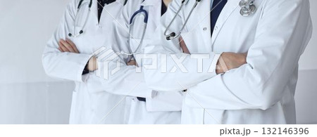 A group of doctors with folded arms demonstrates the professionalism of medicine, mutual support of clinics, and dedication to expert care in a hospital setting A group of doctors with folded arms demonstrates the professionalism of medicine, mutual support of clinics, and dedication to expert care in a hospital setting 132146396