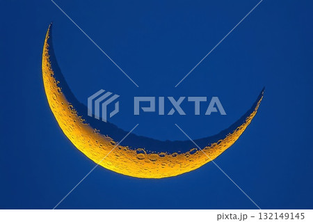Crescent moon against a blue sky. Concept of night, astronomy, and nature. 132149145