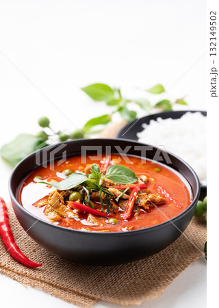 Thai red curry with pork and cooked rice with ingredients on white background 132149502