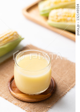 Sweetcorn milk in glass and fresh sweetcorn, Alternative milk from plant, dairy free Sweetcorn milk in glass and fresh sweetcorn, Alternative milk from plant, dairy free 132149504
