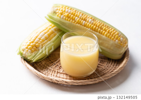 Sweetcorn milk in glass and fresh sweetcorn, Alternative milk from plant, dairy free Sweetcorn milk in glass and fresh sweetcorn, Alternative milk from plant, dairy free 132149505