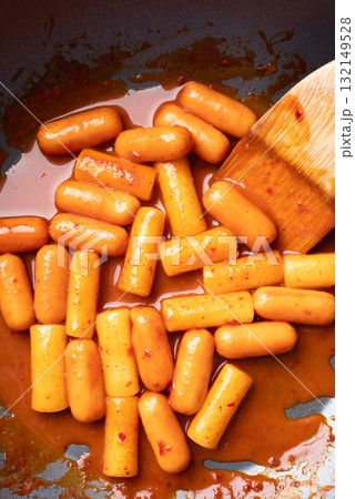 Tteokbokki (simmered rice cake) and sausage with spicy sauce in cooking pan, Korean food 132149528