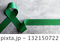 Mental Health Awareness Concept. Green Ribbon lay on Grey background 132150722