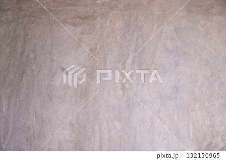 Distressed gray concrete wall texture with exposed aggregate and mottled finish. 132150965