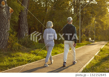 Senior active couple, old spouses enjoy walking outdoor, sporty fit wife and husband going to walk Senior active couple, old spouses enjoy walking outdoor, sporty fit wife and husband going to walk 132152645