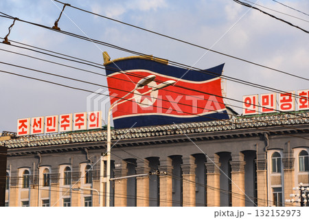 The North Korean flag above Kim Il Sung Square in Pyongyang, North Korea 132152973