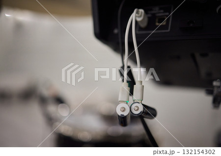 A detailed closeup of audio equipment that is being connected to drums for a performance A detailed closeup of audio equipment that is being connected to drums for a performance 132154302