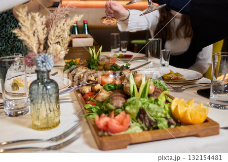 Indulge in an exquisite gourmet platter perfectly paired with a fine red wine selection 132154481