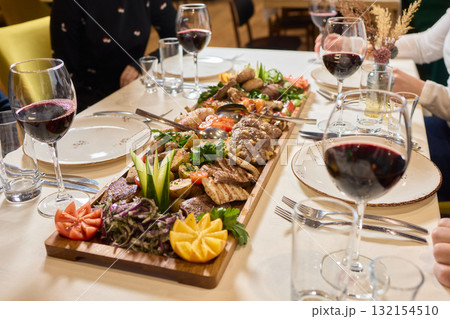 Indulge in an exquisite gourmet platter perfectly paired with a fine red wine selection Indulge in an exquisite gourmet platter perfectly paired with a fine red wine selection 132154510