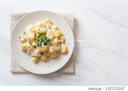 Gnocchi with mushroom cream sauce and cheese 132155287