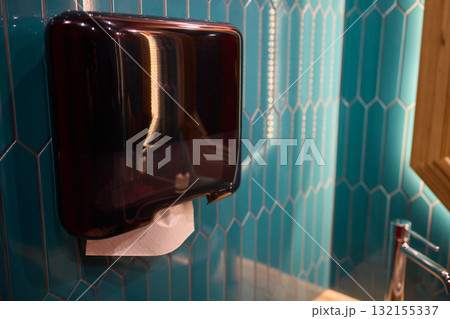 A Modern Bathroom Hand Dryer situated elegantly on stylish hexagonal tiles, enhancing aesthetics 132155337