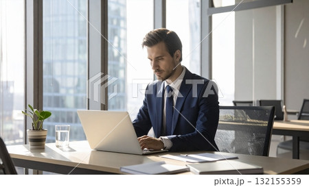オフィスでノートパソコンで真剣に仕事をする若い外国人男性 16:9サイズ AI生成素材 オフィスでノートパソコンで真剣に仕事をする若い外国人男性 16:9サイズ AI生成素材 132155359
