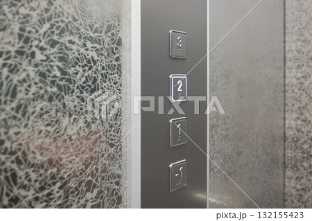 The modern elevator control panel features a display showcasing the current floor number The modern elevator control panel features a display showcasing the current floor number 132155423