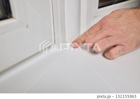 A thorough inspection of the window corner highlights craftsmanship and care with focus 132155863